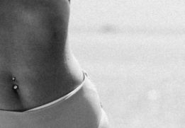 a black and white photo of a woman in a bikini