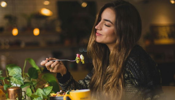woman-holding-fork-in-front-table.jpg woman holding fork in front table