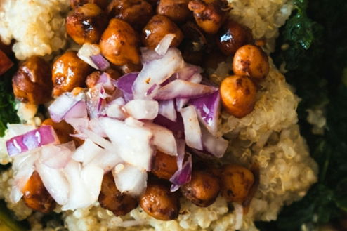 a blue bowl filled with vegetables and rice